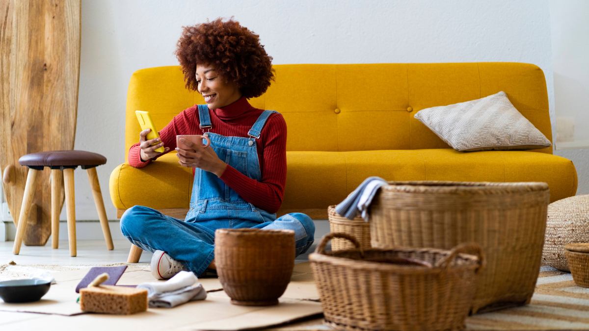 Frau mit Tasse und Handy bastelt