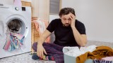 Ein Mann sitzt vor seiner Wäsche und rätselt.