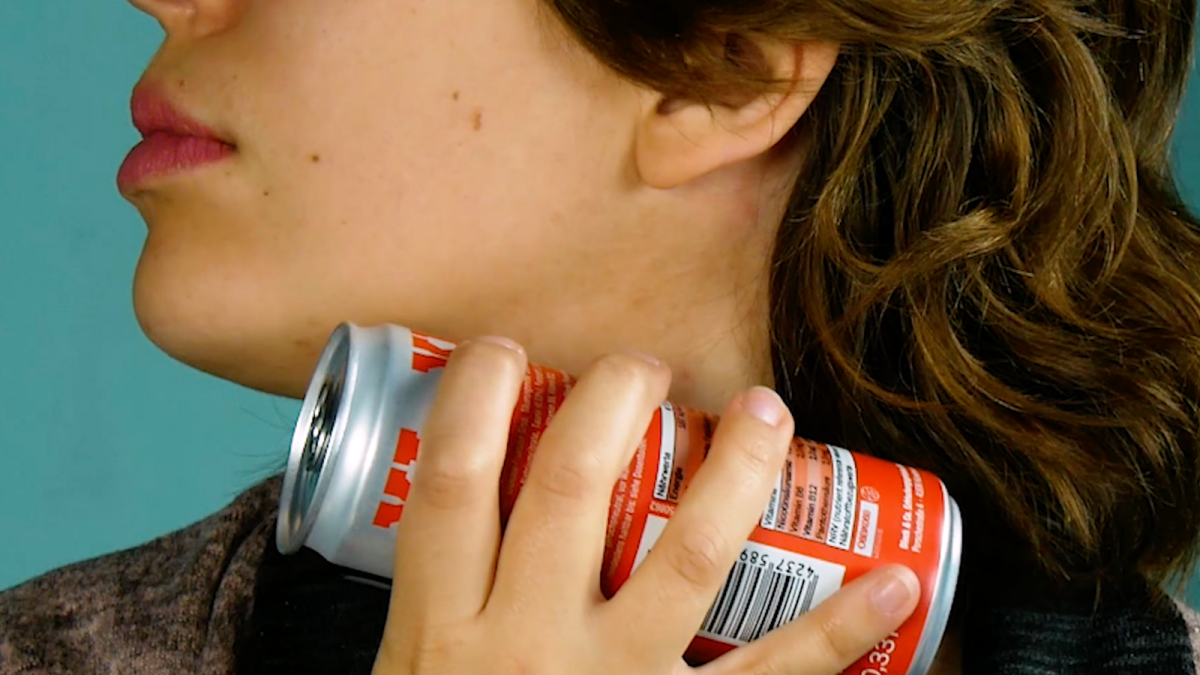 Eine Frau hält sich eine Getränkedose an den Hals.