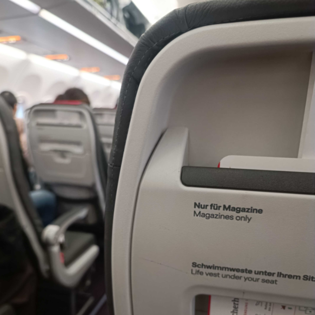 Blick von hinten auf die Lehne eines Sitzplatzes im Flugzeug.