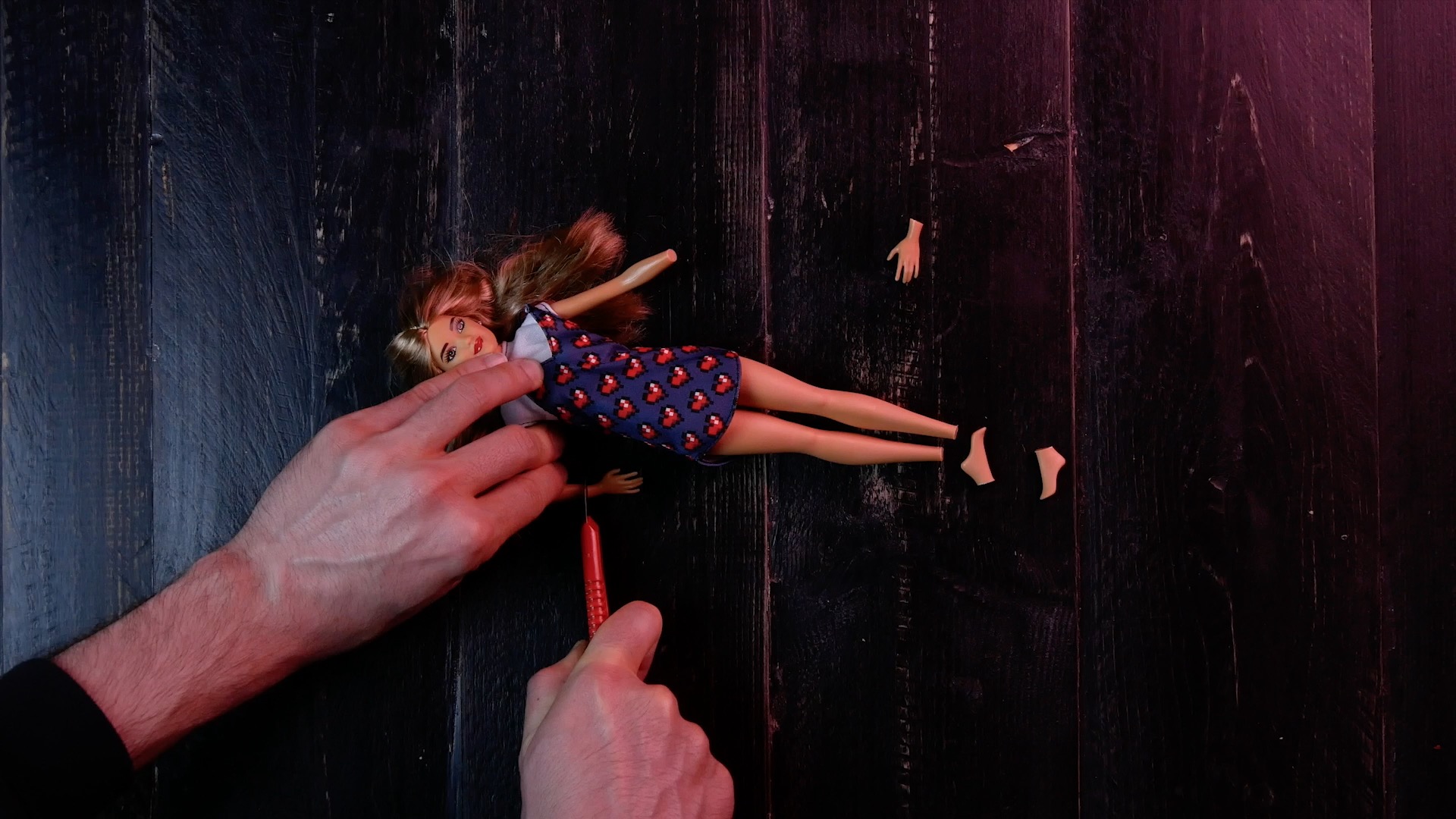 Eine Barbie wird zerschnitten. 