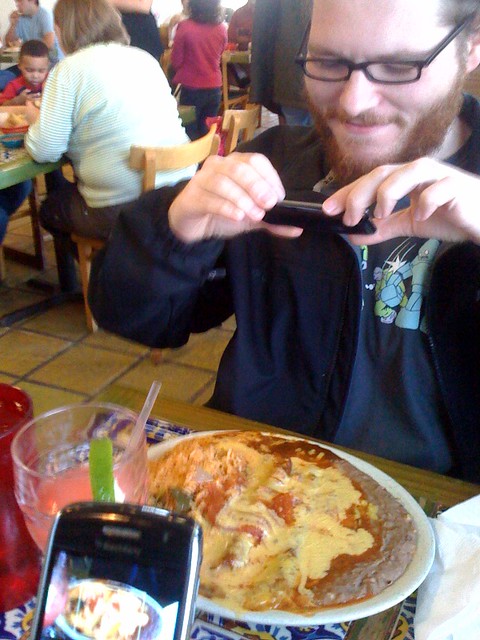 4 people taking a photo of 1 dish
