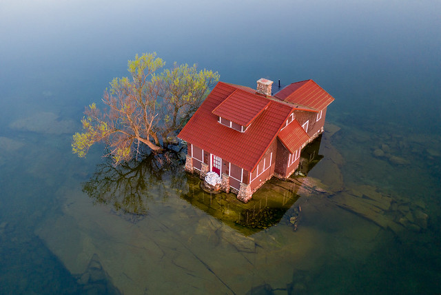 Tiny Island With Red Cottage