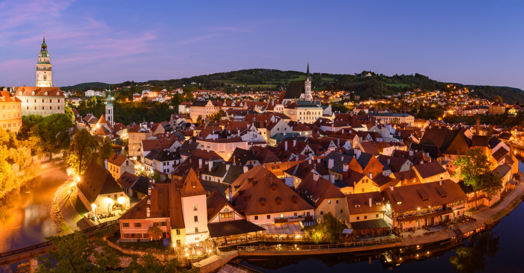 Die erleuchtete Altstadt der tschechischen Stadt Český Krumlov bei Sonnenuntergang.