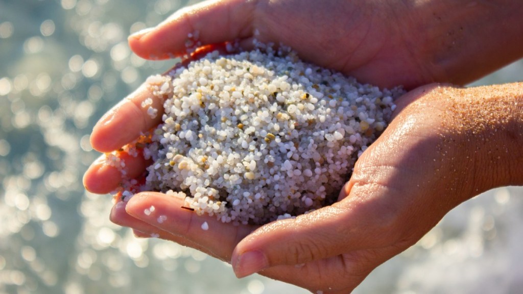 Quarzsand wird in einer Hand gehalten