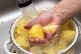 Gekochte Kartoffeln werden in einem Topf mit kaltem Wasser abgeschreckt.