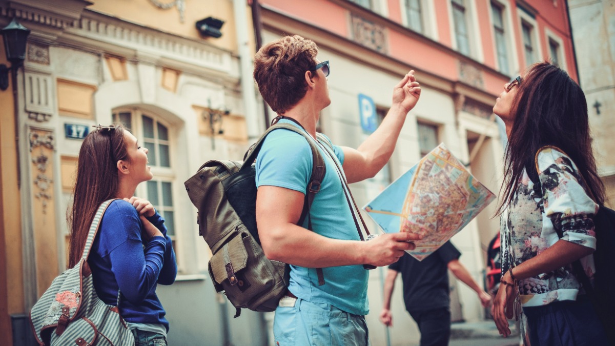 Tourist mit einer Stadtkarte in einer Altstadt.
